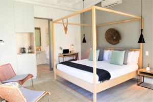 a bedroom with a four poster canopy bed at Cape Diem Lodge in Cape Town +55 photos