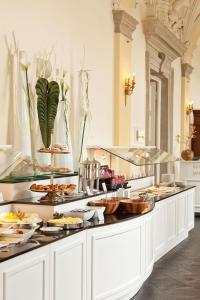 a kitchen filled with lots of different types of food at Althoff Grandhotel Schloss Bensberg in Bergisch Gladbach