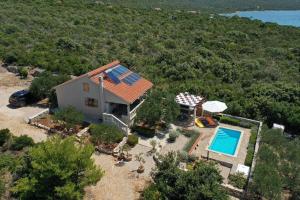 an aerial view of a house with a swimming pool at Robinson House Bosiljka in Dobropoljana