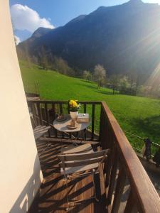 a balcony with a table and chairs and a dog at Chalet Salet in Vernante