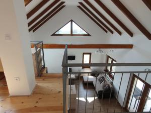 an attic view of a living room with a window at Árvalányhaj Vendégház in Balatonakali