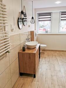 a bathroom with a bowl sink on a wooden cabinet at U Szwagra in Ustka