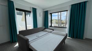 a hospital bed in a room with blue curtains at Palmeras Garden in Playa Blanca +72 photos