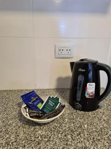 a counter with a coffee pot and a plate of food at SMA FLATS in Neuquén