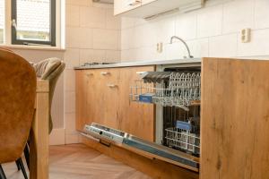 a dishwasher in a kitchen with a sink at 8- person childbungalow - Theme Farm Adapted in Zuna