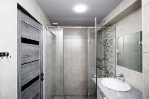 a bathroom with a sink and a glass shower at Excellent apartment in the center of the Yerevan 15 in Yerevan