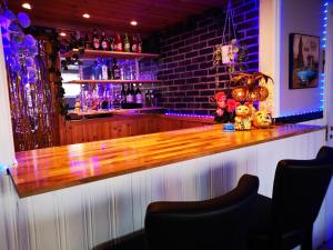 a bar with a wooden counter in a room at Guest House Tidaholm in Tidaholm