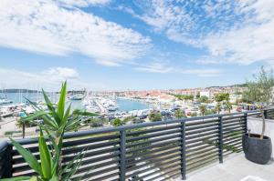 a balcony with a view of a harbor at Apartments and Rooms Mare in Vodice