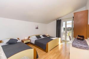 Postel nebo postele na pokoji v ubytování Apartments Manda + 37 fotografií