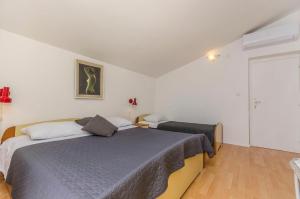 Postel nebo postele na pokoji v ubytování Apartments Manda