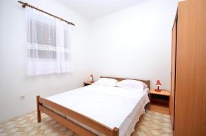 Postel nebo postele na pokoji v ubytování Apartments Kata