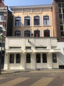 a building with white doors and windows on a street at BnB Bruxelles in Venlo