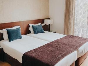Postel nebo postele na pokoji v ubytování Hotel Coroa de Fátima
