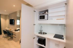 a kitchen with a sink and a microwave at 198 Studios in London