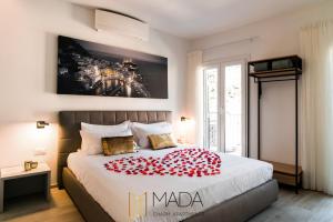 a bedroom with a bed with a red blanket on it at MADA Charm Apartments Jacuzzi in Vernazza