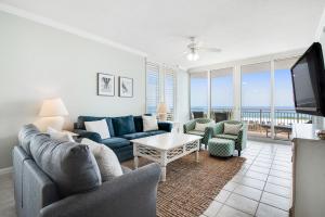 a living room with a couch and chairs and a tv at Pearl Condos in Navarre