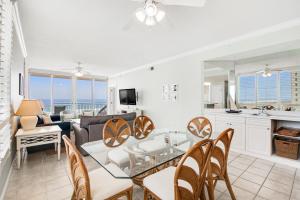 a living room with a glass table and chairs at Pearl Condos in Navarre