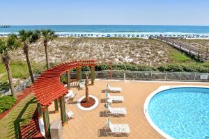 a resort with a swimming pool and a beach at Pearl Condos in Navarre