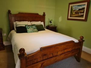 a bedroom with a large bed with white sheets and pillows at Skellys in Ballymahon