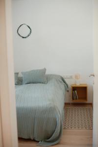 a bedroom with a bed with a blue blanket at Bergauf Appartement in Grossarl