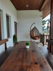 a living room with a wooden table and a chair at Вила Мариам Villa Mariam in Batak