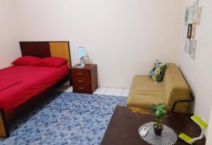a bedroom with a bed and a table and a chair at Alborada minisuites in Guayaquil