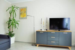 a living room with a tv on a dresser at Romir Pokoje Bardzo Gościnne in Sztutowo
