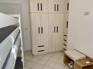 a bedroom with a bunk bed and wooden cabinets at PORTA HOME modern and hospitable in Naxos Chora +37 photos