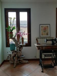 een kamer met een tafel en een tafel met bloemen erop bij cà bianca in Latisana