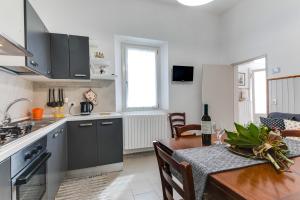 a kitchen and dining room with a table and a dining room at Casemurate di Ravenna in Casemurate