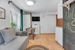 a living room with a couch and a table at Apartament w Dolnym Sopocie w przyziemiu by Grand Apartments in Sopot