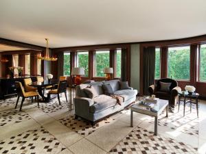 a living room with a couch and a table at 45 Park Lane - Dorchester Collection in London