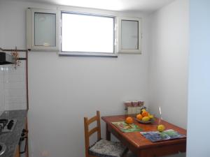 a small kitchen with a table and a window at Moonlight house in Praiano