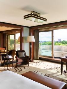 a hotel room with a bed and a large window at 45 Park Lane - Dorchester Collection in London