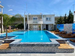 a swimming pool in front of a house at Blue Star Apartments in Ulcinj