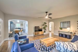 a living room with blue furniture and a tv at Updated Fayetteville Home Less Than 2 Miles to UArk! in Fayetteville
