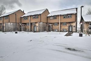 a group of buildings in the snow at Cozy Condo Ski-In and Out with Burke Mountain Access! in East Burke
