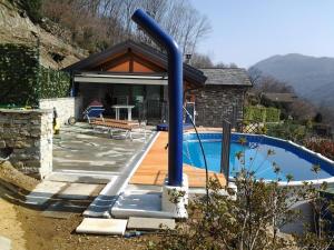 a house with a swimming pool and a house at Casa delle Betulle in Verbania