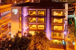 a building with purple lights on the side of it at Hotel Casa Fortuna in Kolkata