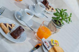 a table with a plate of cake and a cup of coffee at Residenza L'Alzoni in San Teodoro