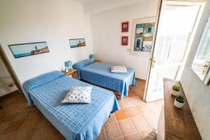Postel nebo postele na pokoji v ubytování Casa Rossa Lacona