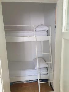 a white closet with white towels on a shelf at numero uno in Lido di Jesolo