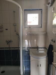 łazienka z prysznicem, toaletą i umywalką w obiekcie Kertes nyaralóház w mieście Keszthely