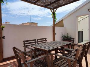 a wooden table and chairs on a patio at Flats Friends Torres Quart in Valencia