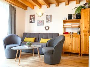 a living room with a couch and two chairs and a table at Tatralandia Apartman 347 in Liptovský Mikuláš