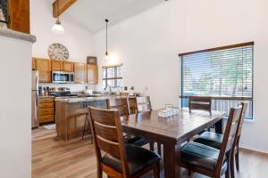 a kitchen and dining room with a wooden table and chairs at Pines 4043 in Pagosa Springs