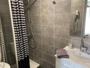 uma casa de banho com um chuveiro e um lavatório. em Hôtel Restaurant Le Provençal em Le Grau-du-Roi