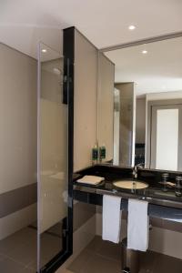 a bathroom with a sink and a mirror at Vila Gale Douro Vineyards in Armamar +37 photos