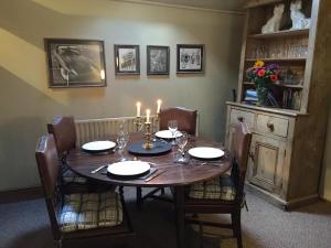 a dining room with a table with candles on it at Cosy 2 bedroom apartment, terrace with Hot Tub 8am - 10pm plus private daily use of indoor pool and sauna 1 hour in Stanton in Peak