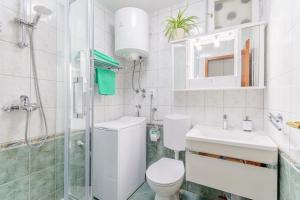 a bathroom with a toilet and a sink and a shower at Apartment Vinka in Split